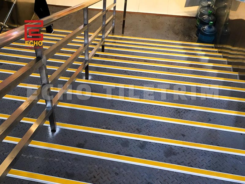 Aluminum stair nosing installed on modern staircase edge
